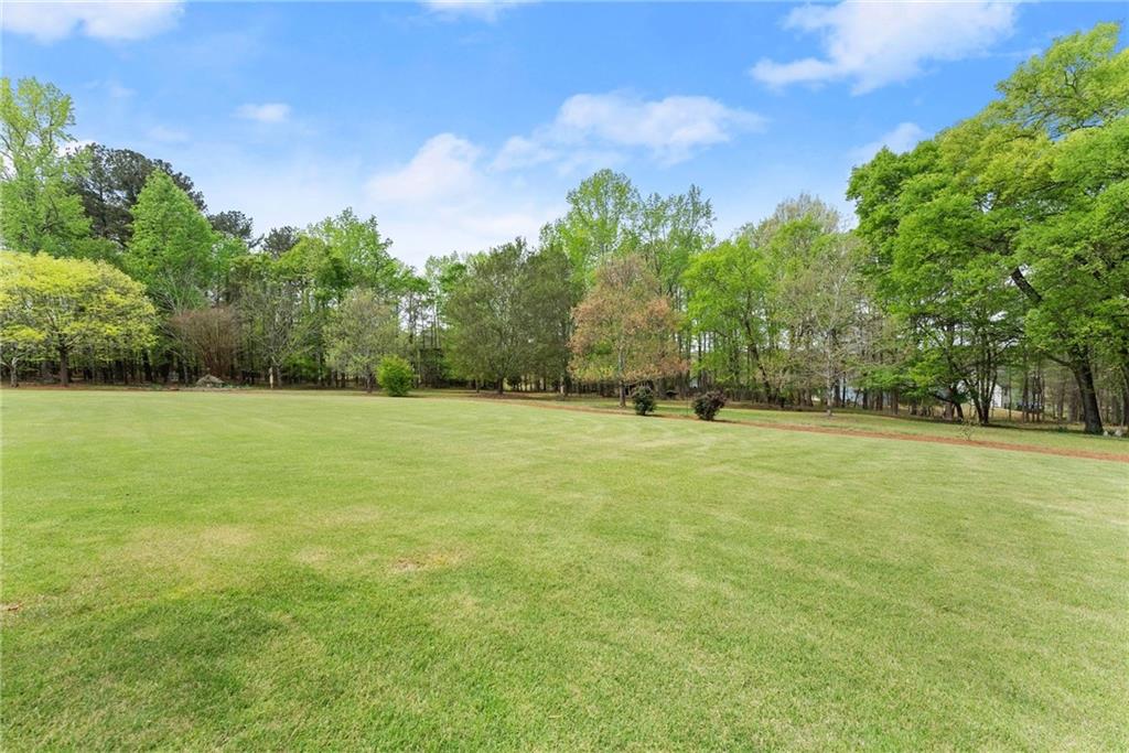 594 Peachtree Road Hoschton, GA 30548 - Photo 88 of 96 a view of outdoor space with deck and trees