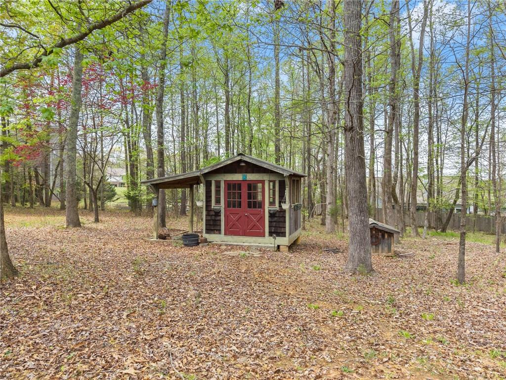 594 Peachtree Road Hoschton, GA 30548 - Photo 92 of 96 a view of a house with a yard and large trees