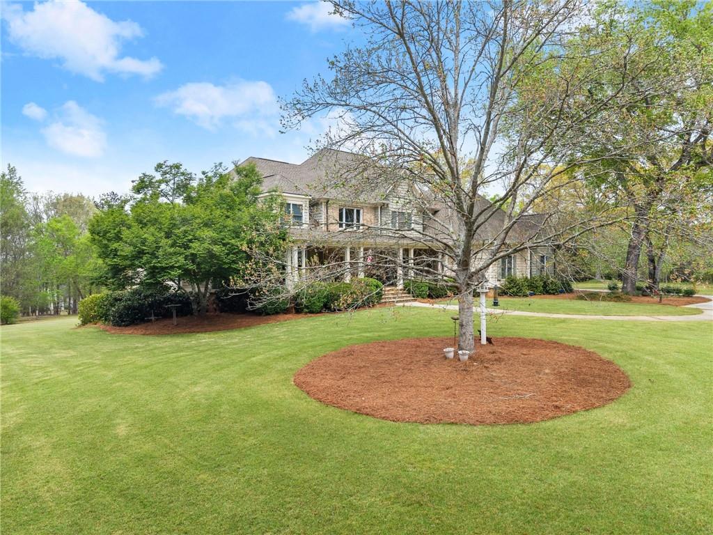 594 Peachtree Road Hoschton, GA 30548 - Photo 10 of 96 a view of a fountain in front of a house with a fountain