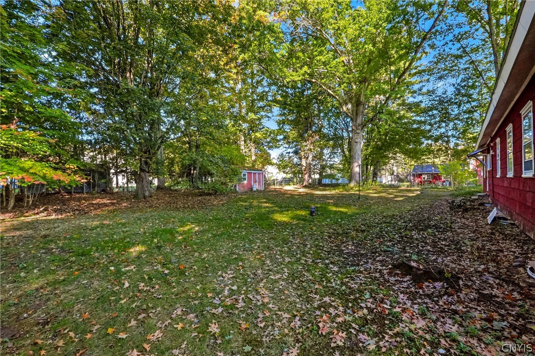 7779 Bell Road North Rome, NY 13440 - Photo 38 of 38 Mature trees shade a spacious grassy yard bordering the side of the home.