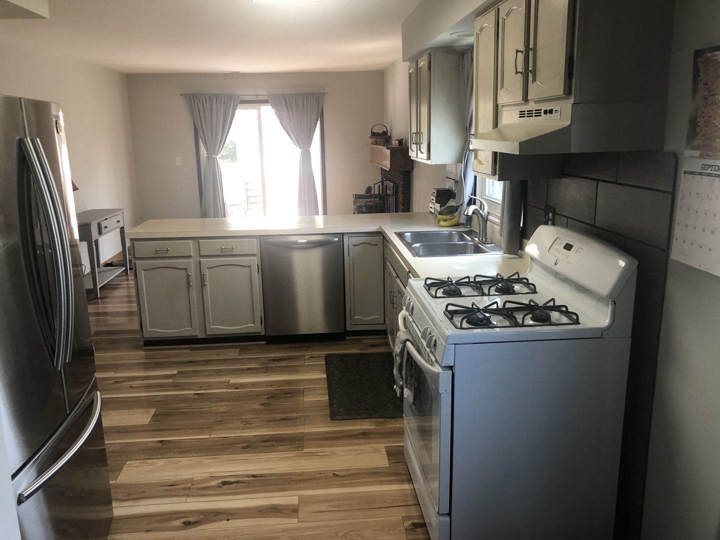 2235 Ridge Avenue Aurora, IL 60504 - Photo 8 of 17 a kitchen with granite countertop a sink stove and refrigerator