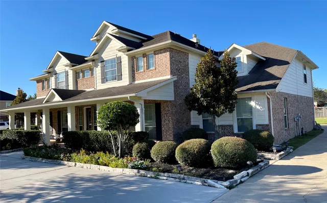 a front view of a house with a garden