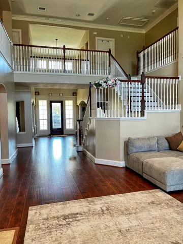 a living room with a couch and wooden floor