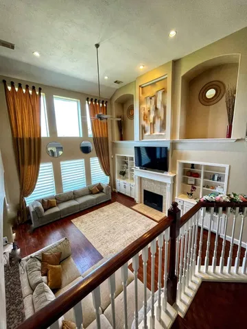 a view of a livingroom with furniture window fireplace and hall