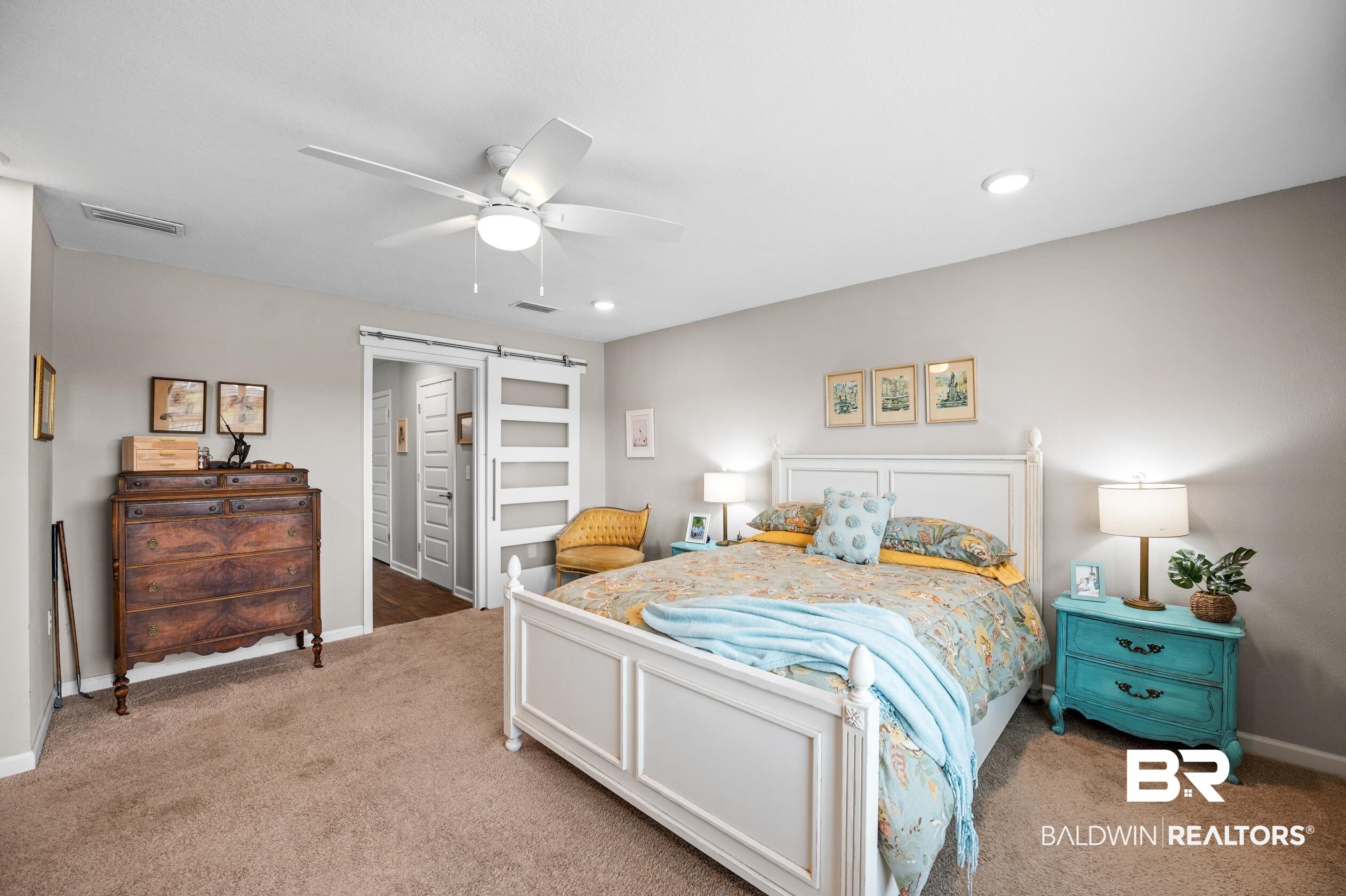 8161 Irwin Loop Daphne, AL 36526 - Photo 18 of 32 Carpeted bedroom with ceiling fan and a barn door