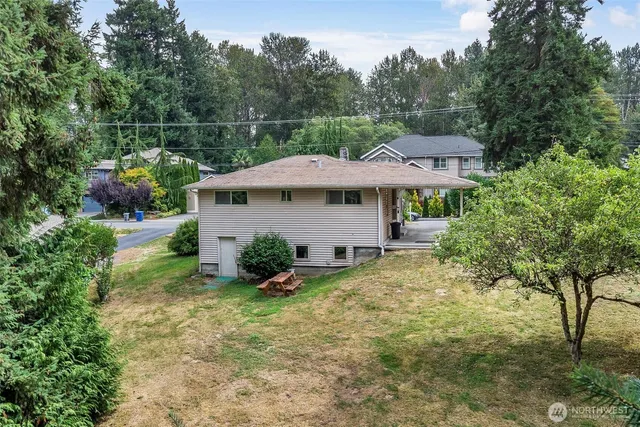 a view of a house with a yard and sitting area