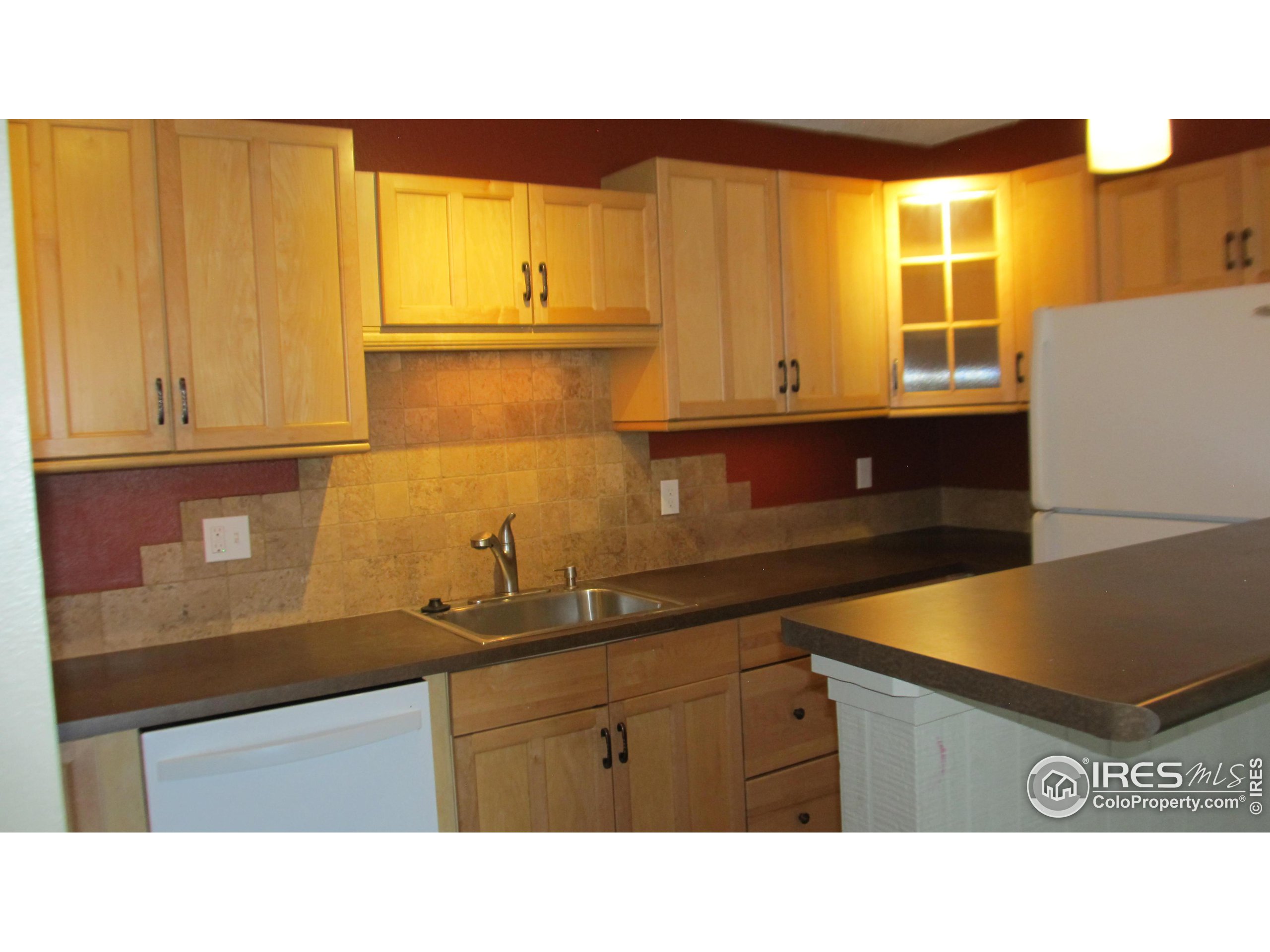 a kitchen with stainless steel appliances kitchen island granite countertop a sink window and cabinets