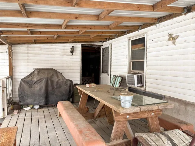 a view of balcony with wooden floor and seating space