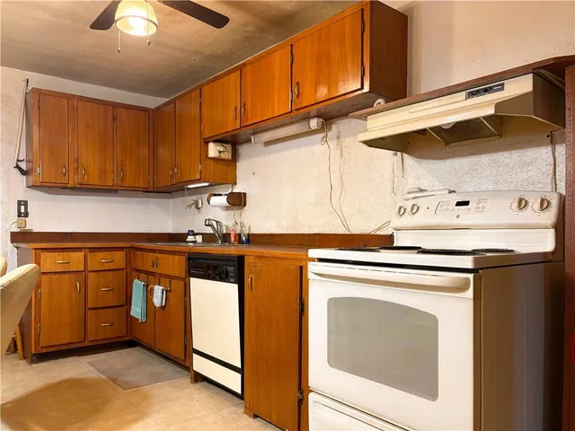 a kitchen with stainless steel appliances granite countertop a sink a stove and a microwave oven