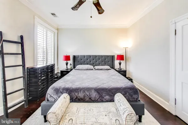 a bedroom with a bed and a large window