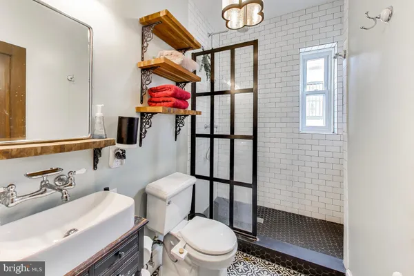 a bathroom with a toilet sink and mirror