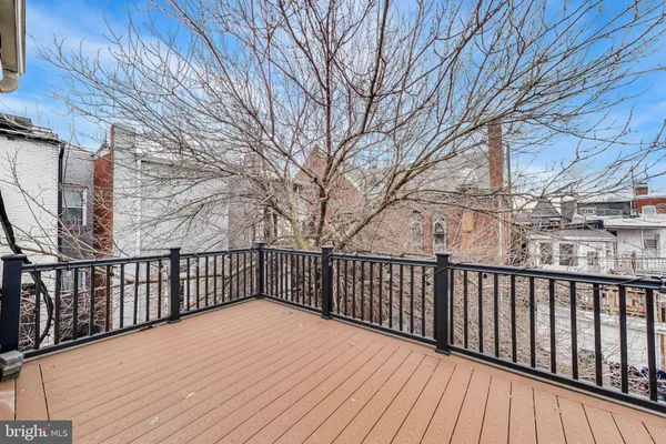 a balcony with wooden floor and fence
