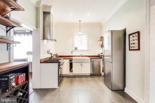 a kitchen with a refrigerator and a sink