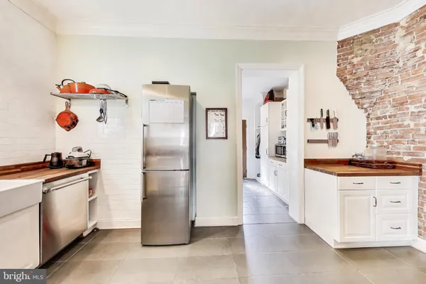 a kitchen with a stove top oven and refrigerator