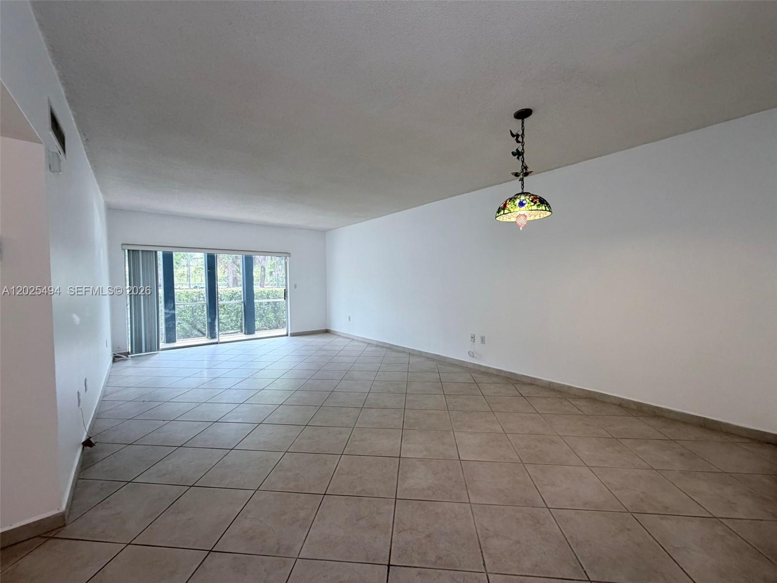 9159 Southwest 77th Avenue, Unit 112 Miami, FL 33156 - Photo 12 of 38 a view of an empty room with a window