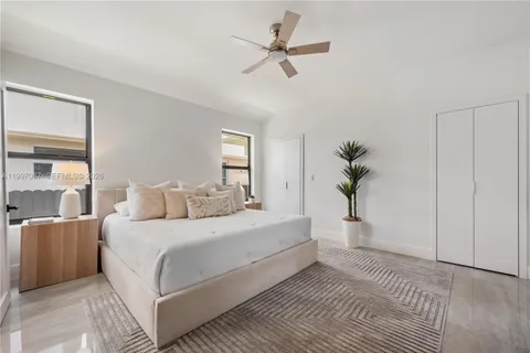 a bedroom with a large bed and a chandelier