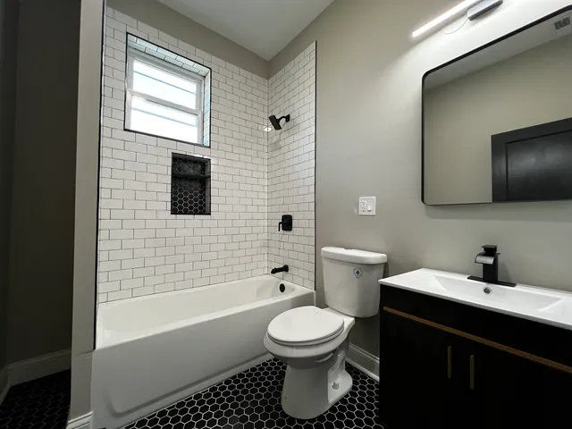 a kitchen with a sink a stove a refrigerator and cabinets