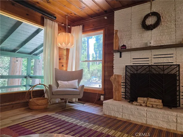 a living room with furniture a window and a fireplace