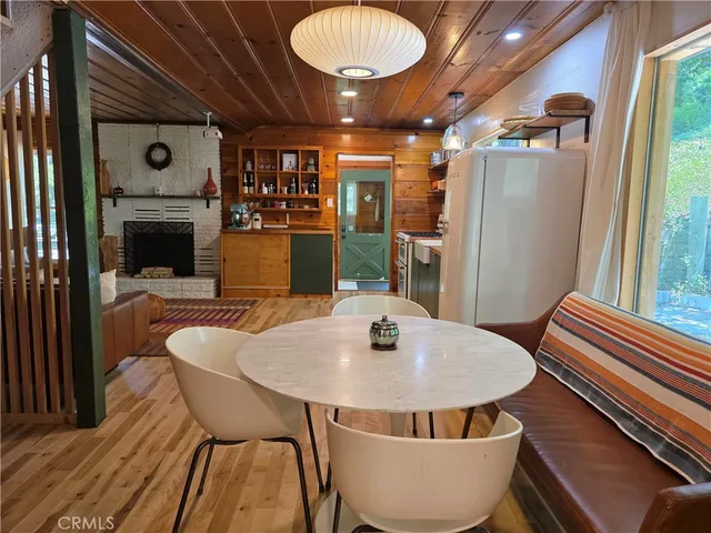 a dining room with furniture and wooden floor