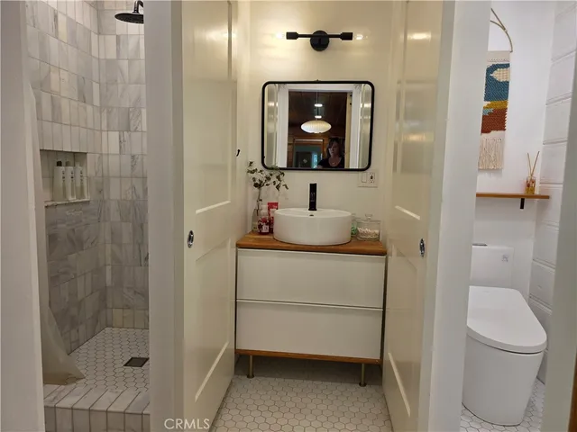 a bathroom with a toilet sink and shower