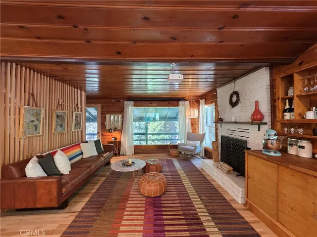 a living room with furniture fireplace and window