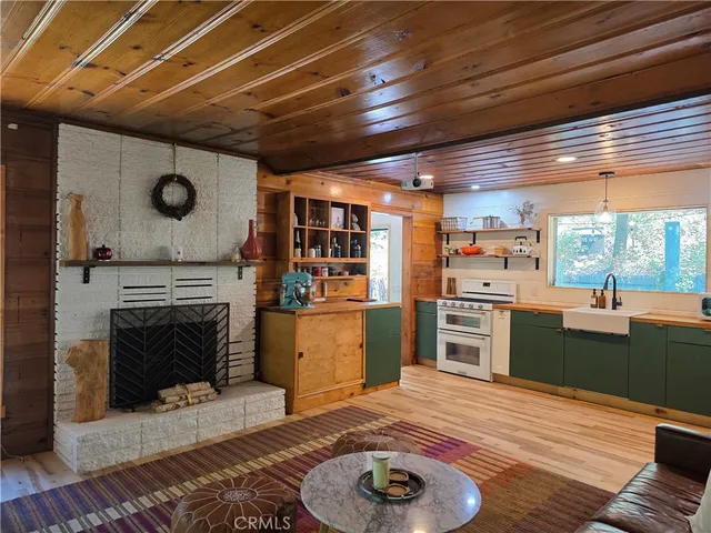a kitchen with furniture and a fireplace