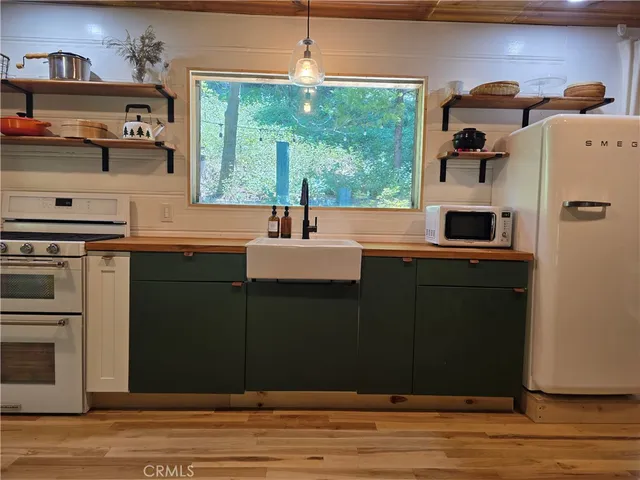 a kitchen with a sink cabinets and appliances