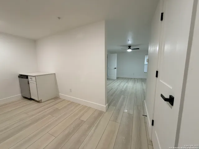 a view of an empty room and wooden floor