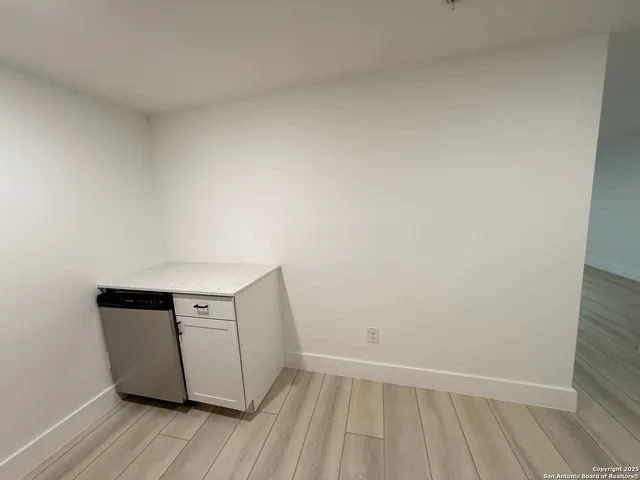 a view of an empty room and wooden floor