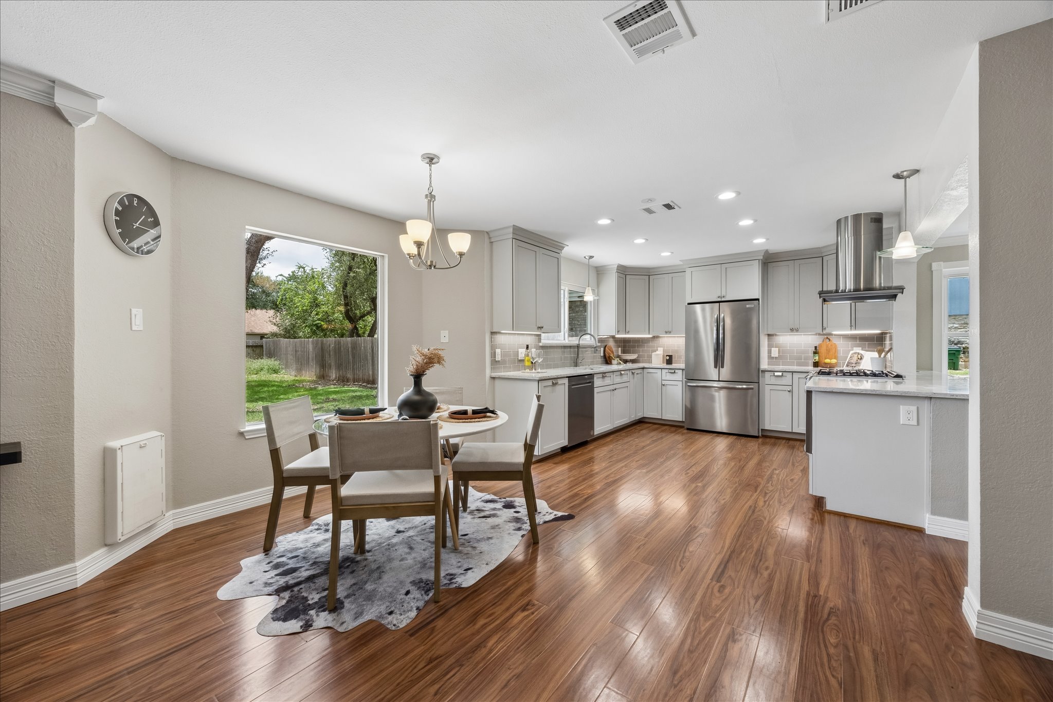 1306 Shady Grove Path Cedar Park, TX 78613 - Photo 8 of 40 a kitchen with a dining table chairs and refrigerator