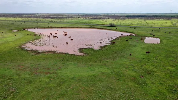 an aerial view of a golf course with a ocean view