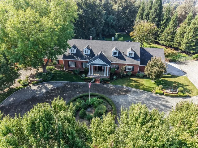 a living room with furniture and a dining table