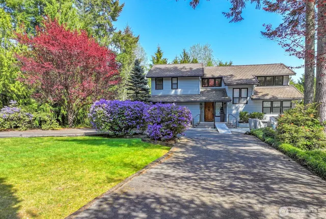 a front view of a house with a garden