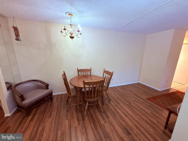 a view of a dining room with furniture wooden floor and chandelier