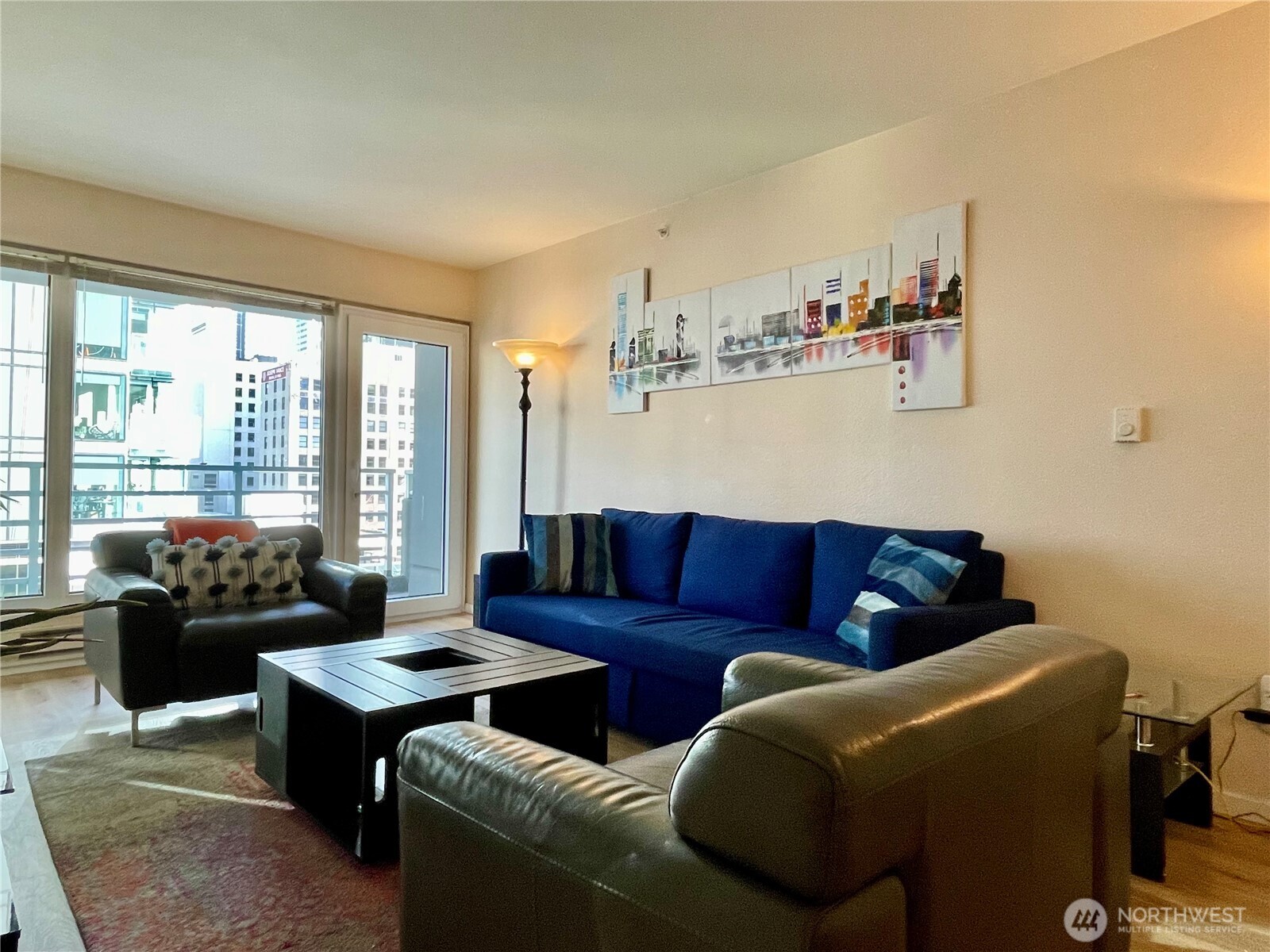 1415 2nd Avenue, Unit 1106 Seattle, WA 98101 - Photo 11 of 30 a living room with furniture and a floor to ceiling window
