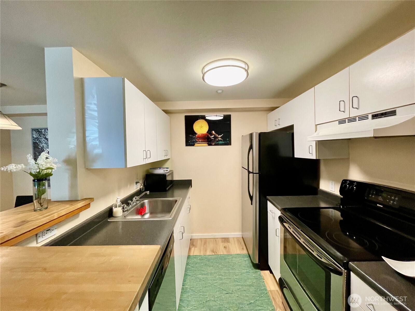 1415 2nd Avenue, Unit 1106 Seattle, WA 98101 - Photo 16 of 30 a kitchen with a sink stove and refrigerator