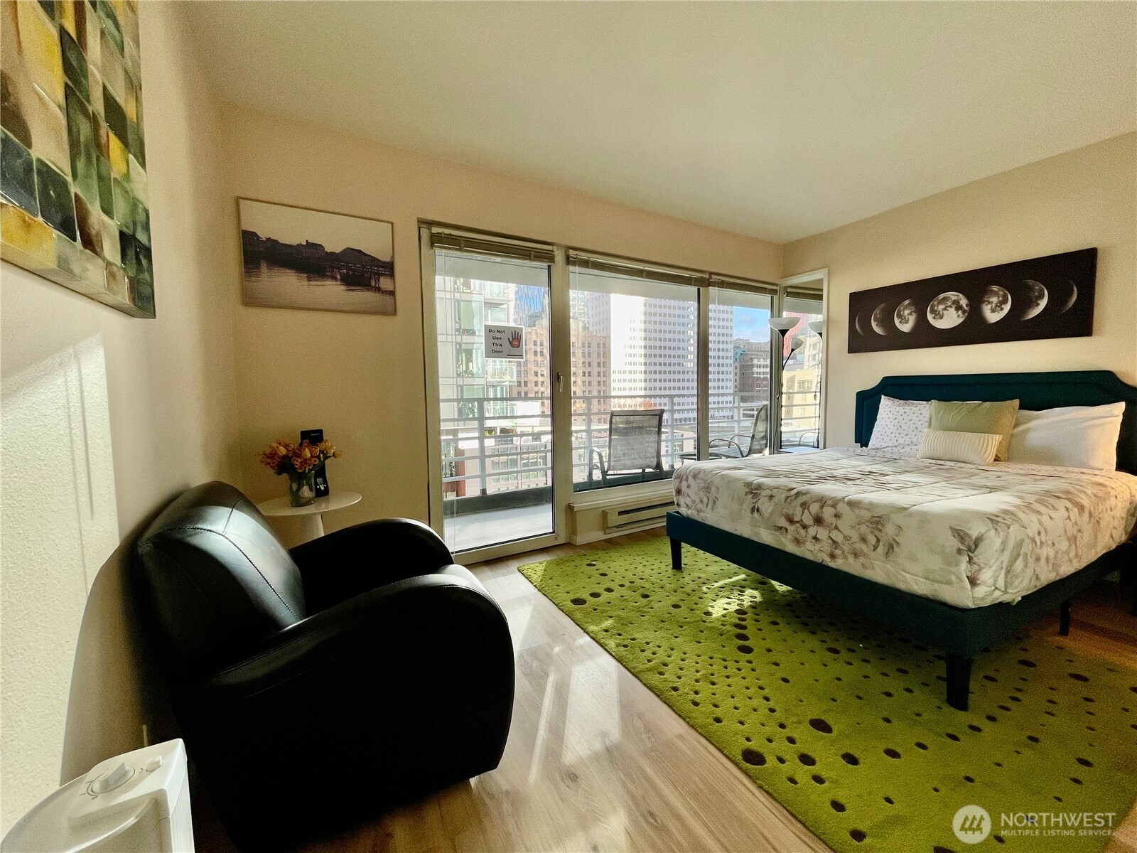 1415 2nd Avenue, Unit 1106 Seattle, WA 98101 - Photo 21 of 30 a bedroom with a bed and a couch