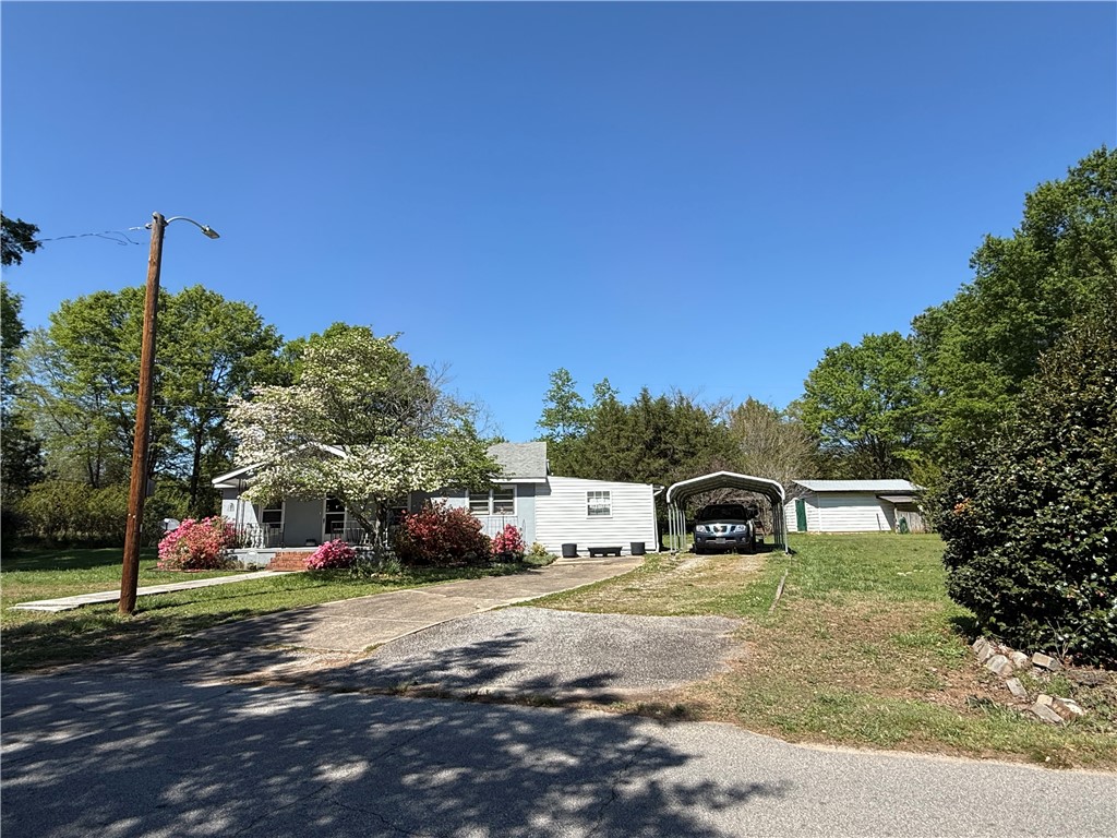 615 Taylor Street Central, SC 29630 - Photo 13 of 16 This property features a spacious yard and convenient covered parking, ideal for outdoor living.