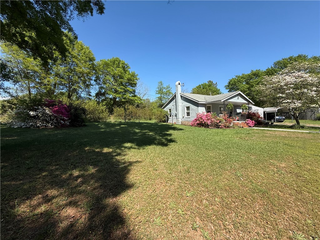 615 Taylor Street Central, SC 29630 - Photo 3 of 16 This charming home features a covered porch, mature trees, and a spacious yard.