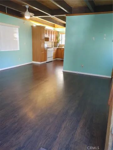 a view of a room with wooden floor