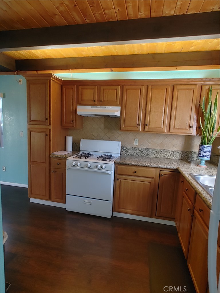 32981 Deer Lane Running Springs, CA 92382 - Photo 5 of 16 a kitchen with stainless steel appliances granite countertop a stove a sink and a microwave