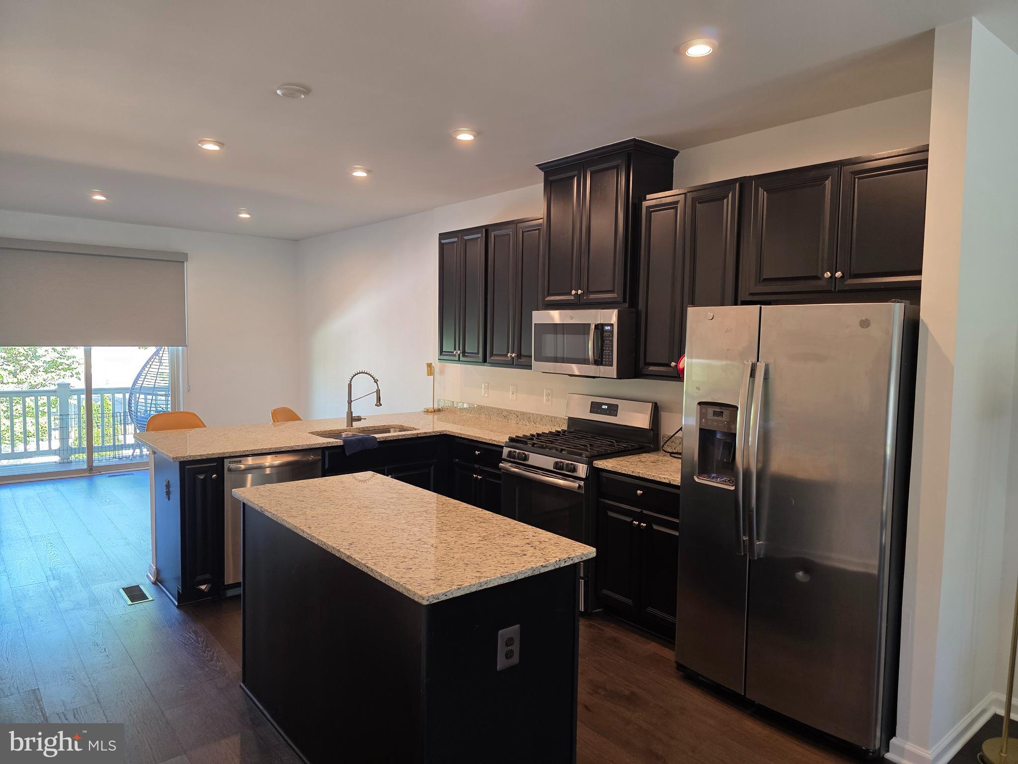 43815 Stubble Cor Square Ashburn, VA 20147 - Photo 2 of 23 a kitchen with stainless steel appliances a sink a stove a refrigerator and cabinets