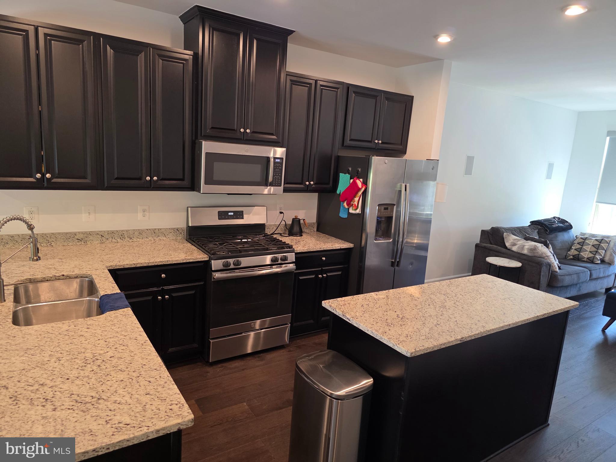 43815 Stubble Cor Square Ashburn, VA 20147 - Photo 3 of 23 a kitchen with a sink stove and refrigerator