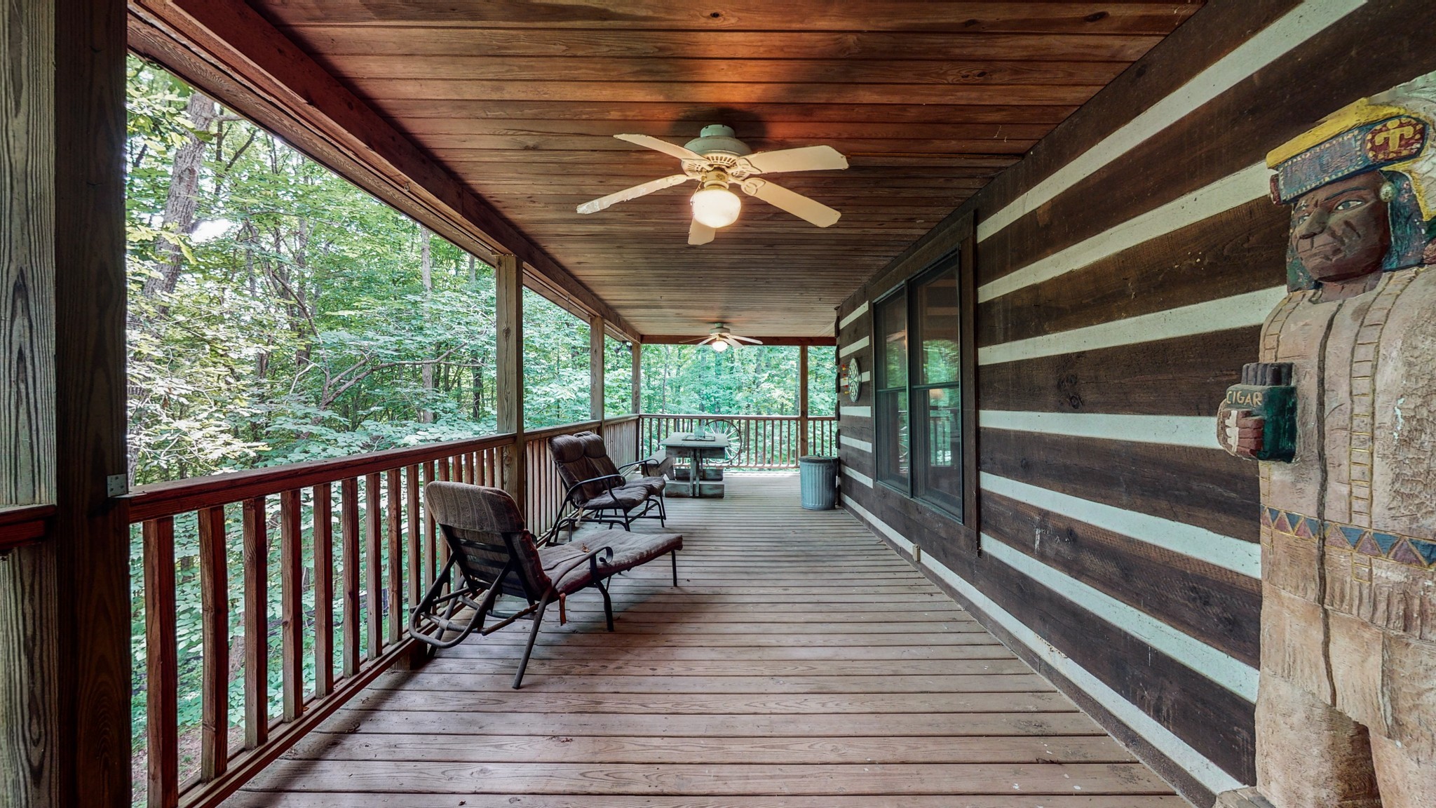 7715 Fernvale Road Fairview, TN 37062 - Photo 30 of 46 a view of a porch with wooden floor chairs and a table
