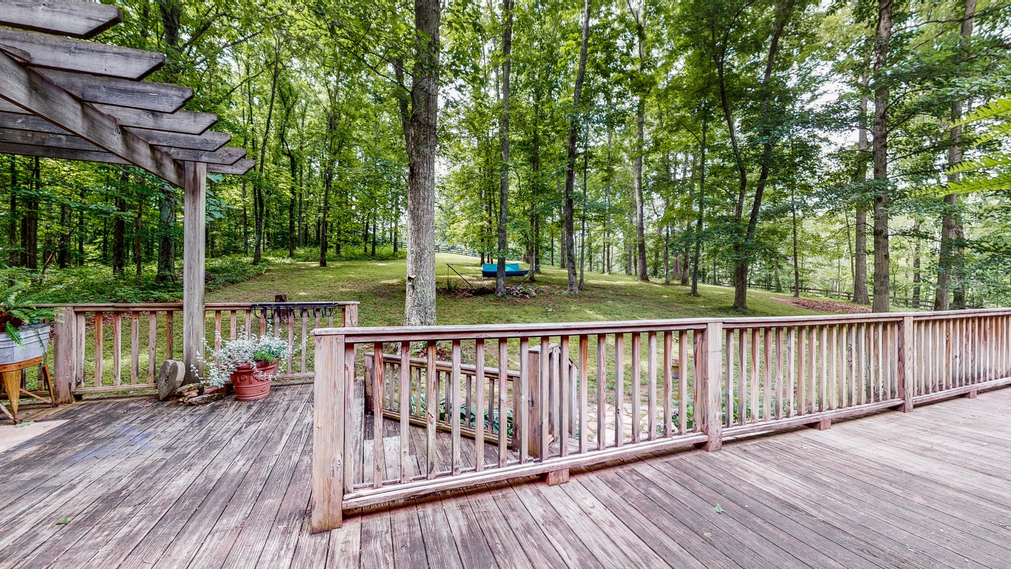 7715 Fernvale Road Fairview, TN 37062 - Photo 36 of 46 a view of a wooden deck with a large pool and a yard