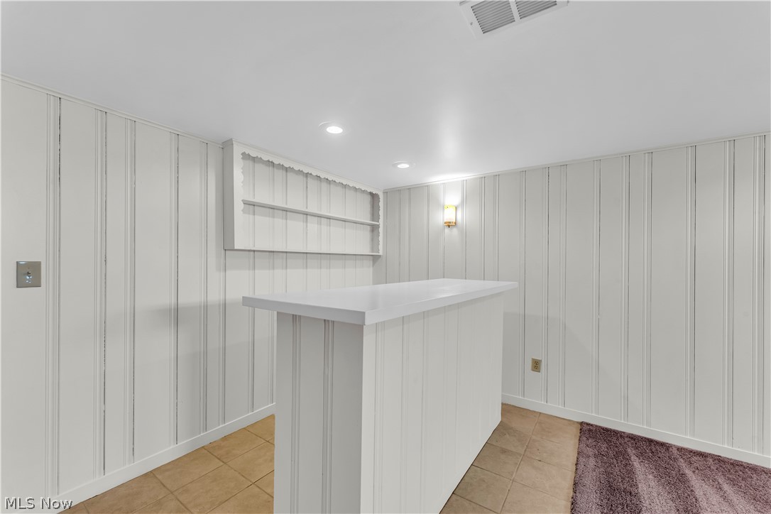 9716 Alexander Road Cleveland, OH 44125 - Photo 25 of 30 Bar featuring light tile patterned floors, light countertops, and recessed lighting
