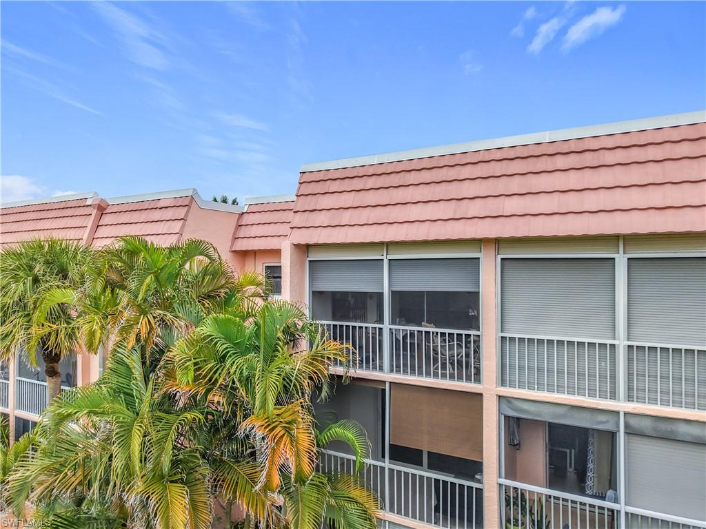 150 Turtle Lake Court, Unit 309 Naples, FL 34105 - Photo 31 of 42 a view of a balcony with a plants and wooden fence