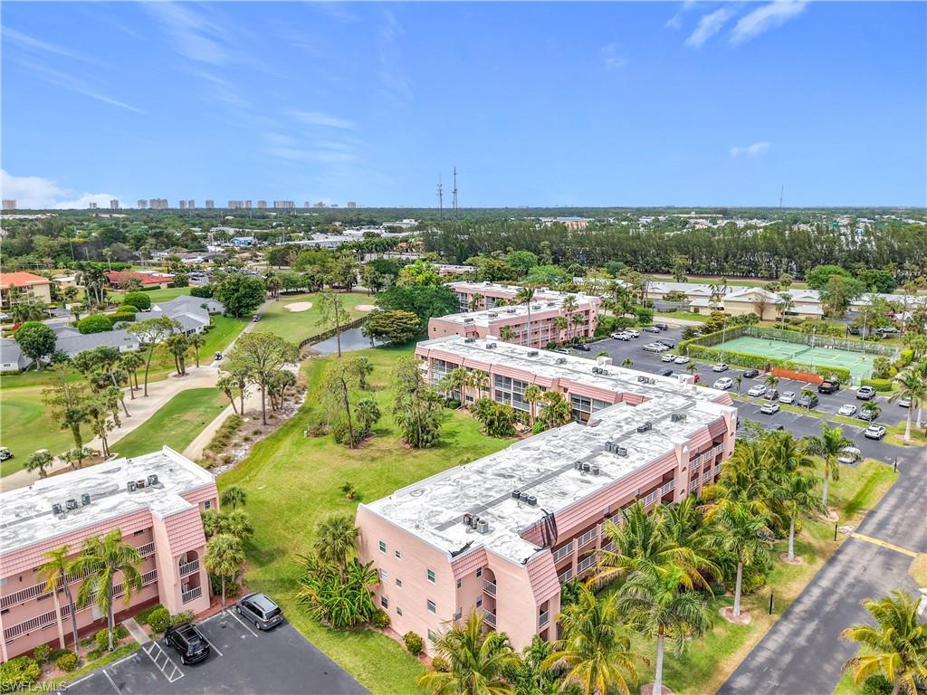 150 Turtle Lake Court, Unit 309 Naples, FL 34105 - Photo 36 of 42 an aerial view of residential houses with outdoor space and trees