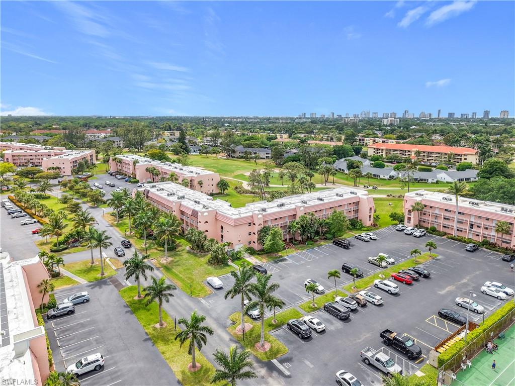 150 Turtle Lake Court, Unit 309 Naples, FL 34105 - Photo 8 of 42 an aerial view of a city with lots of residential buildings ocean and mountain view in back