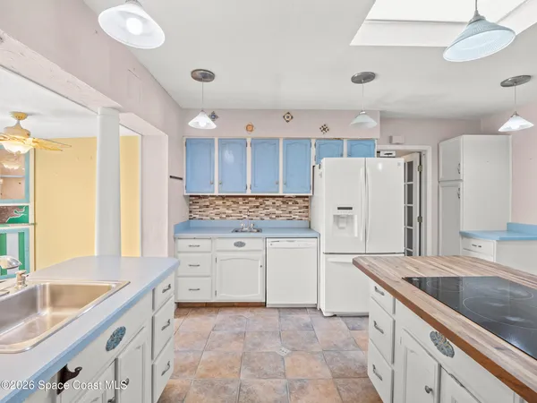a kitchen with a sink stove and refrigerator